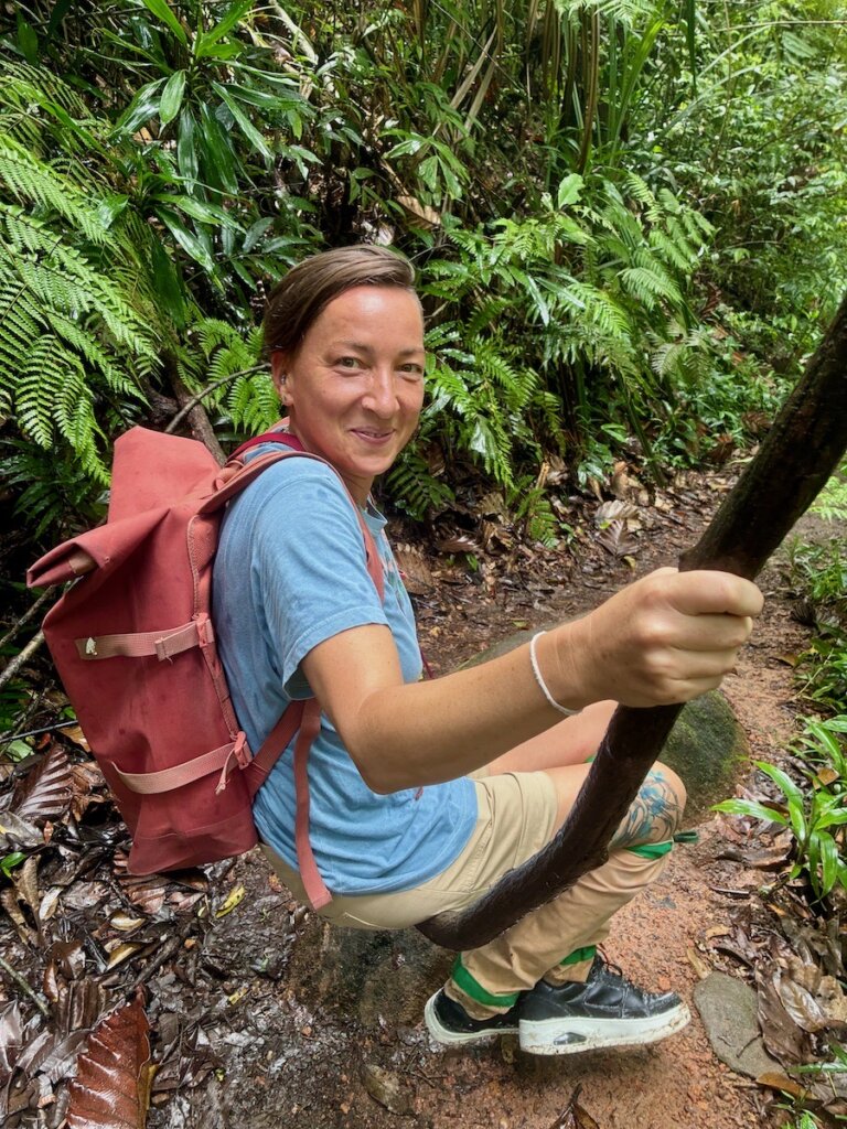 Sinharaja Rain Forest, woman sitting on a vine
